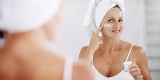 Woman Applying Cream to Her Face